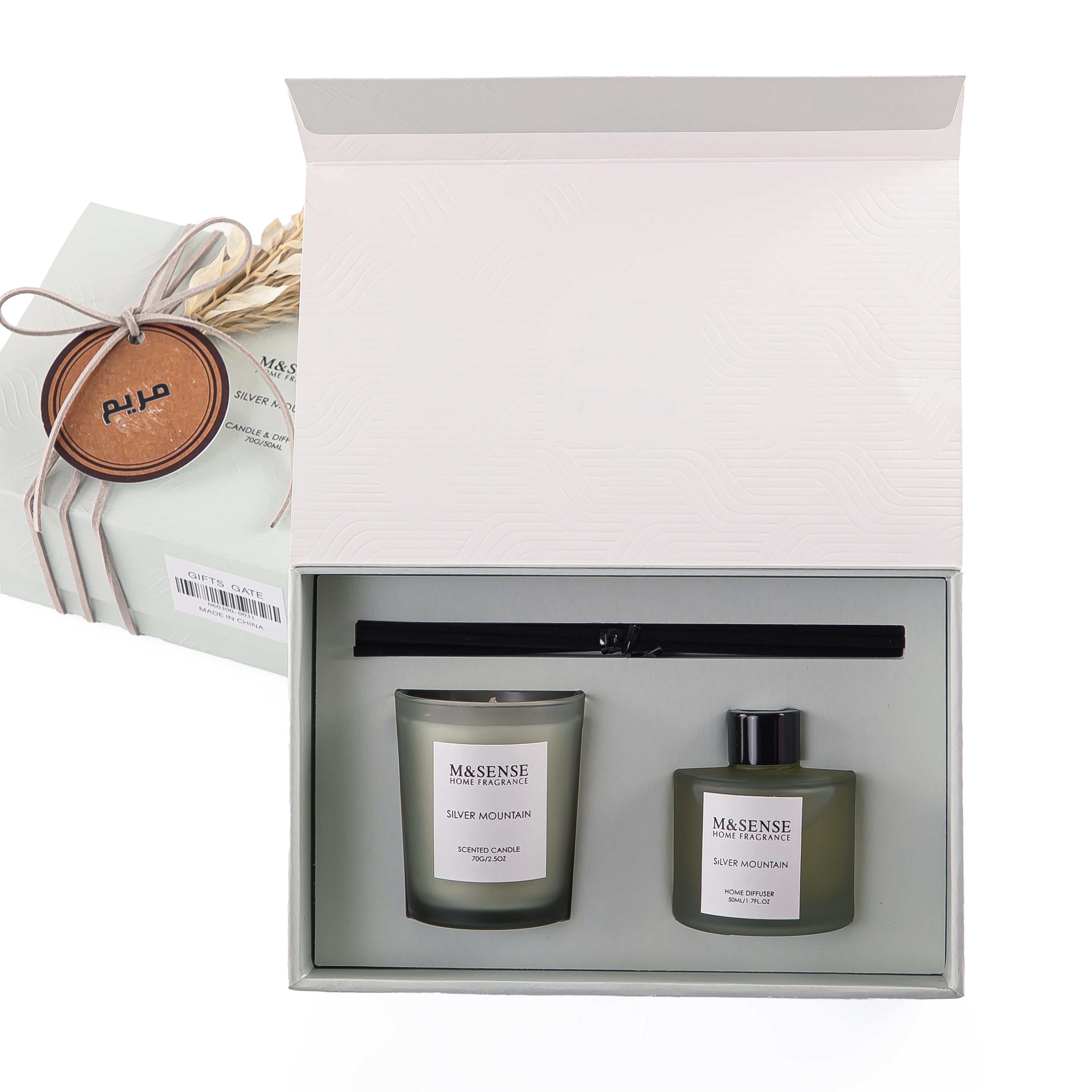 Rectangular decorated green box with a customized name label, containing a diffuser, candle, and five sticks