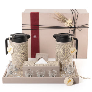 A grey tray holding two thermoses with fabric covers, six coffee glasses, six tea glasses, six coasters, three labels "Tea, Karak, Coffee", and tissue box with gift box
