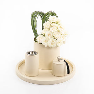 An off-white leather set includes circle tray, incense burner, jar, and flower vase