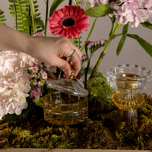 A tray decorated with various types of flowers, an incense burner and bowls