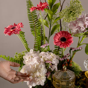A tray decorated with various types of flowers, an incense burner and bowls