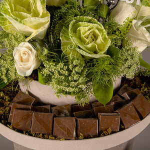 A chocolate tray decorated with white roses