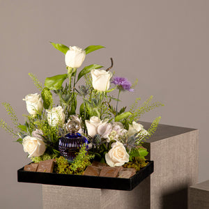 A chocolate tray with perfume from the Signature Collection, decorated with white roses
