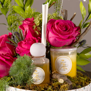 pink roses in a circular box with diffuser and candle