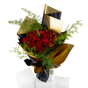 Elegant hand-tied bouquet featuring fresh red roses