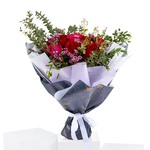 Elegant hand-tied bouquet featuring fresh deferent types of flowers