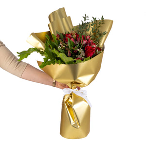 Elegant hand-tied bouquet featuring fresh red roses