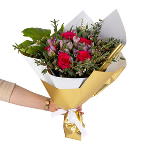 Elegant hand-tied bouquet featuring fresh deferent types of flowers