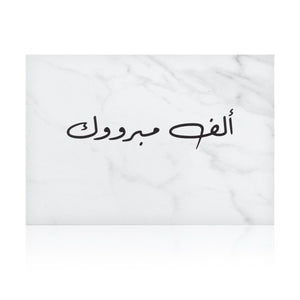 white marble greeting card with the words 'ألف مبروك' written on it