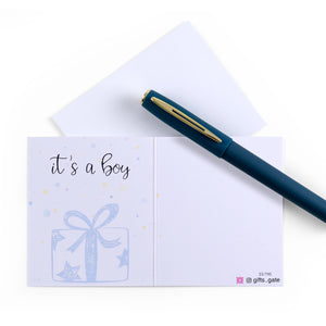 White and blue new baby boy greeting card with the words 'It's a boy' written on it