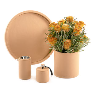 A brown leather set includes circle tray, incense burner, jar, and flower vase
