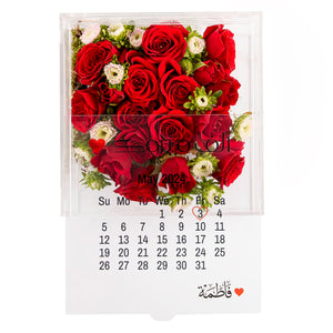 An Acrylic box with calendar and customized name, filled with different types of flowers