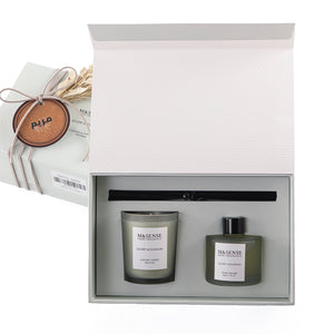 Rectangular decorated green box with a customized name label, containing a diffuser, candle, and five sticks