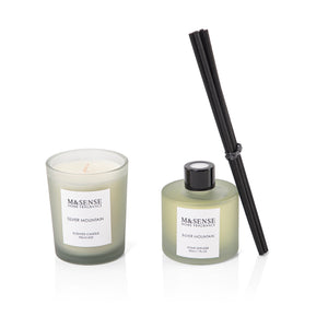 green diffuser, candle, and five sticks