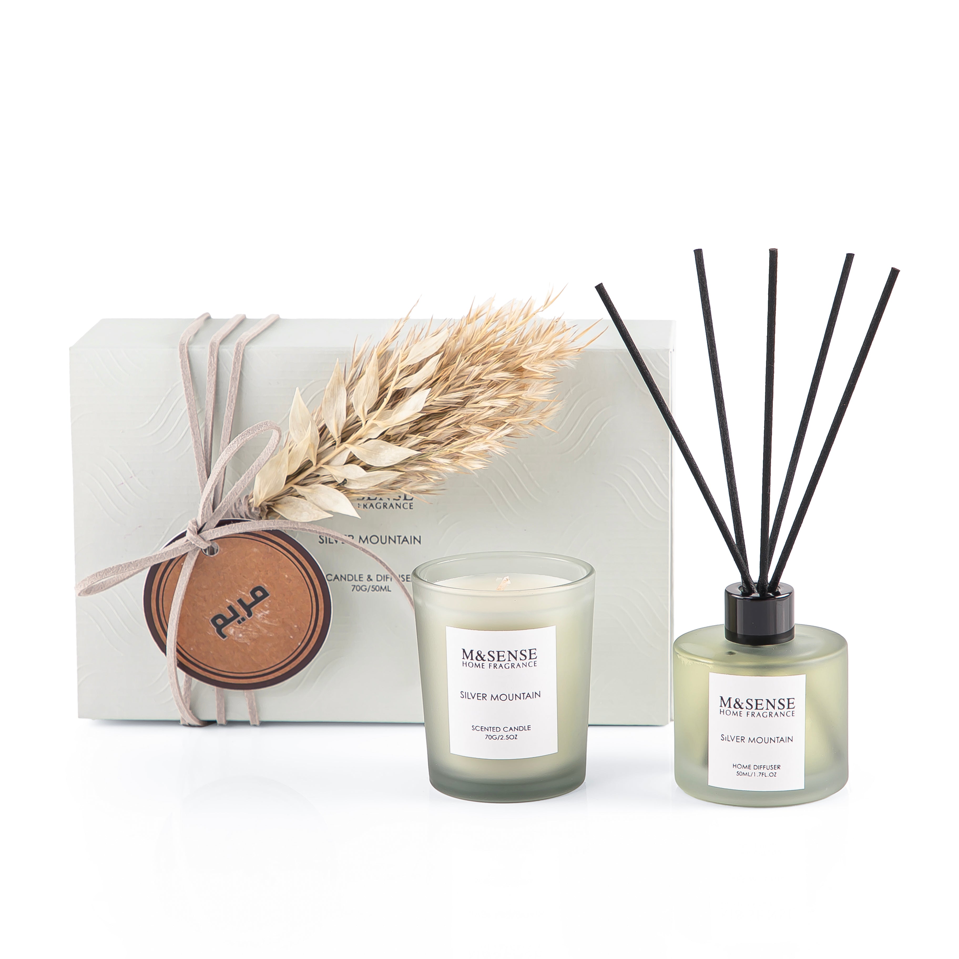 Rectangular decorated green box with a customized name label, containing a diffuser, candle, and five sticks