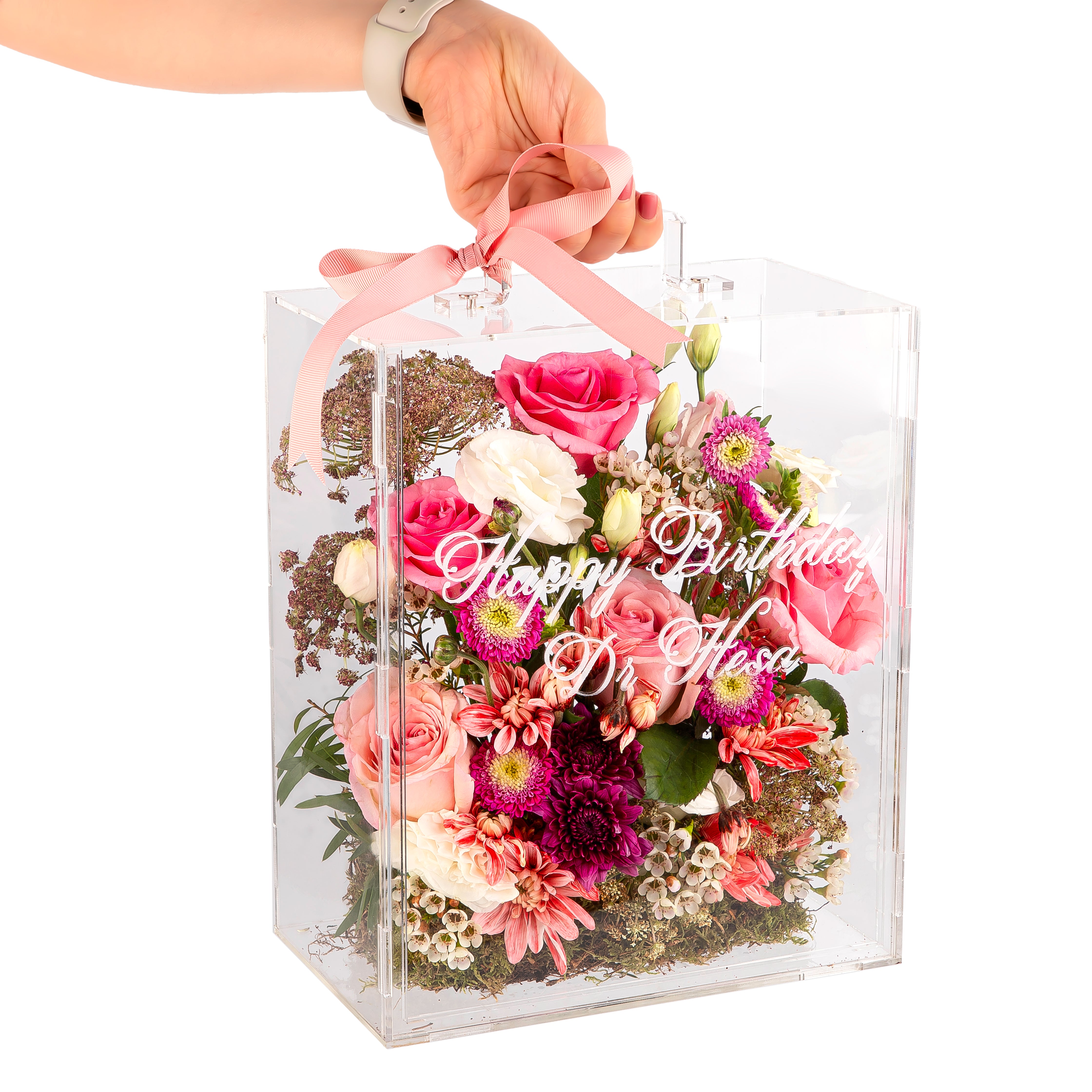 An Acrylic box filled with different types of flowers with customized name