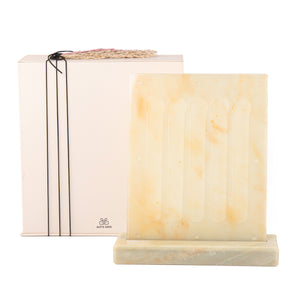 A beige/yellow Nespresso capsules stand