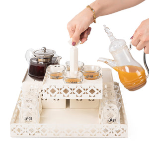 A beige metal set contains tray, two stands, 8 coffee glasses, 6 tea glasses, and metal coasters