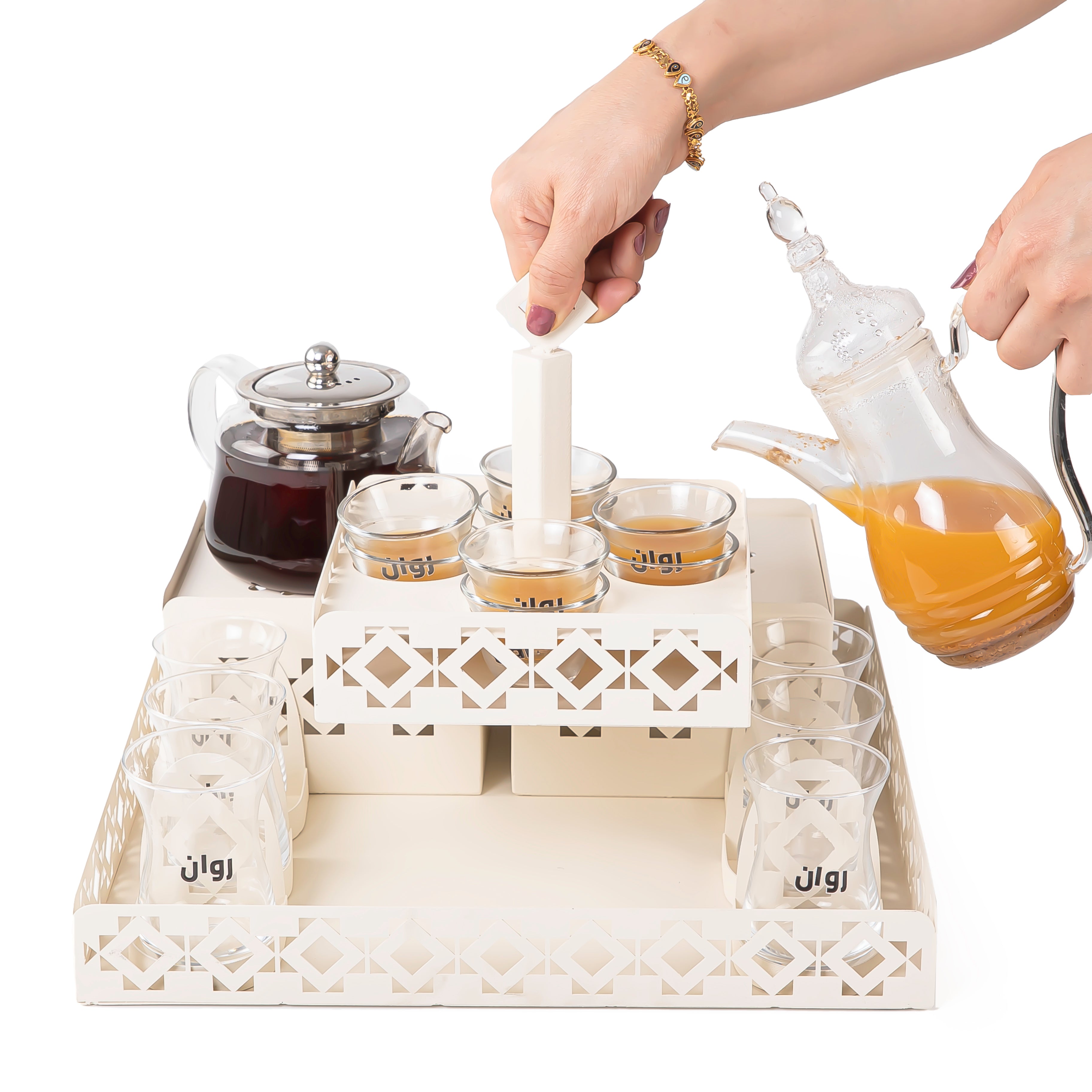 A beige metal set contains tray, two stands, 8 coffee glasses, 6 tea glasses, and metal coasters
