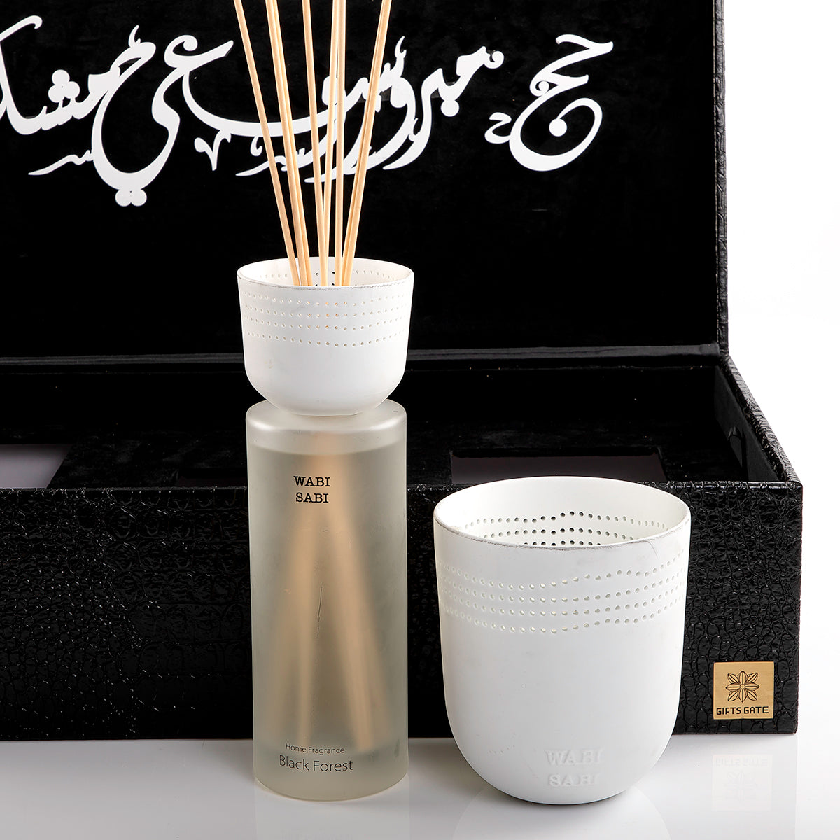 black box contains diffuser, sticks, and candle decorated with customized sentence or name
