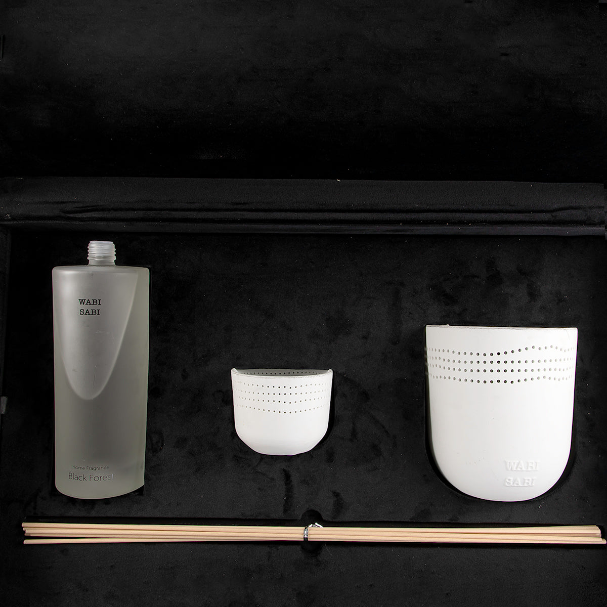 black box contains diffuser, sticks, and candle decorated with customized sentence or name