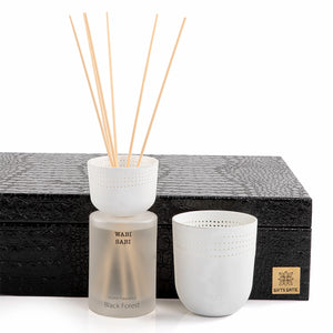 black box contains diffuser, sticks, and candle decorated with customized sentence or name