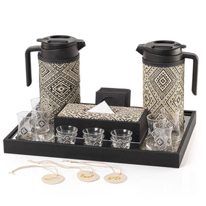 A black tray holding two thermoses with fabric covers, six coffee glasses, six tea glasses, six coasters, three labels "Tea, Karak, Coffee", and tissue box