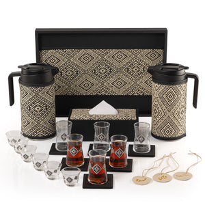 A black tray holding two thermoses with fabric covers, six coffee glasses, six tea glasses, six coasters, three labels "Tea, Karak, Coffee", and tissue box