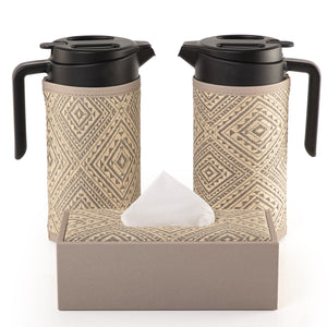 two thermoses with grey fabric covers and tissue box