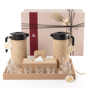 A beige tray holding two thermoses with fabric covers, six coffee glasses, six tea glasses, six coasters, three labels "Tea, Karak, Coffee", and tissue box with a gift box