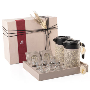 A grey tray holding two thermoses with  fabric covers, six coffee glasses, six tea glasses, six coasters, three labels "Tea, Karak, Coffee" with a gift box