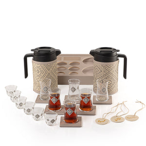 A grey tray holding two thermoses with  fabric covers, six coffee glasses, six tea glasses, six coasters, three labels "Tea, Karak, Coffee"