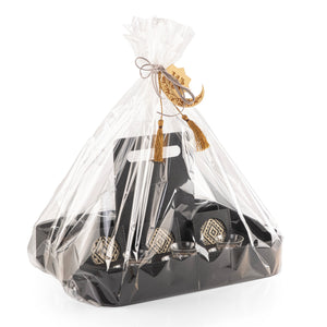 A black stand with a handle, holding six coffee glasses, six tea glasses, and six coasters