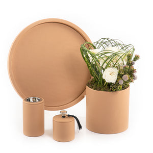 A brown leather set includes circle tray, incense burner, jar, and flower vase