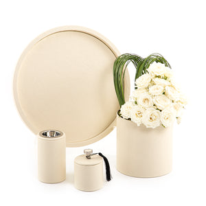An off-white leather set includes circle tray, incense burner, jar, and flower vase