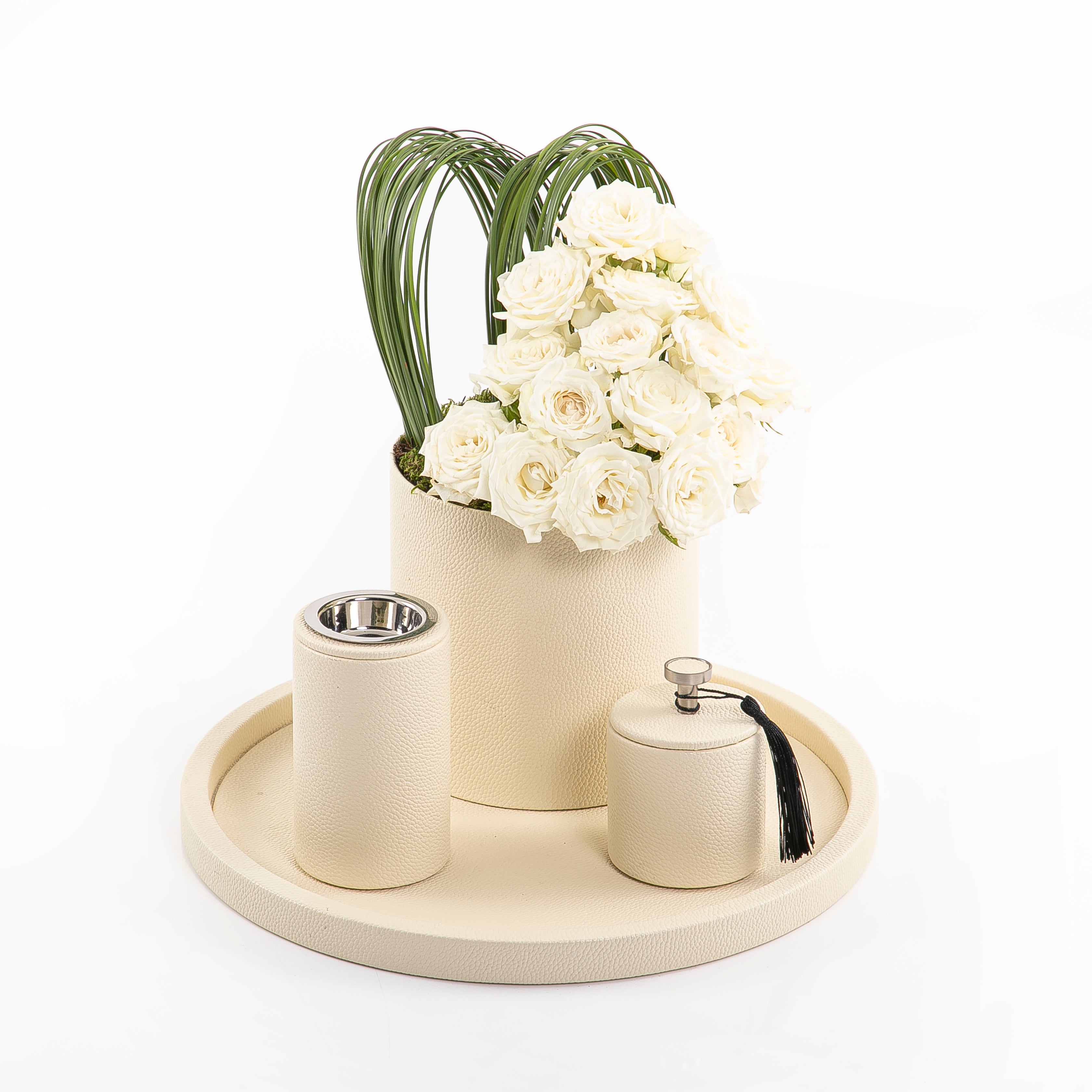 An off-white leather set includes circle tray, incense burner, jar, and flower vase