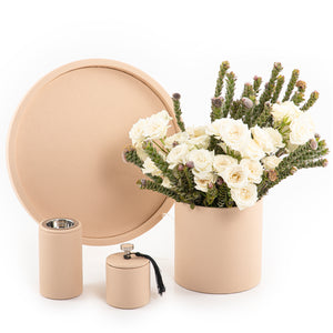 A beige leather set includes circle tray, incense burner, jar, and flower vase