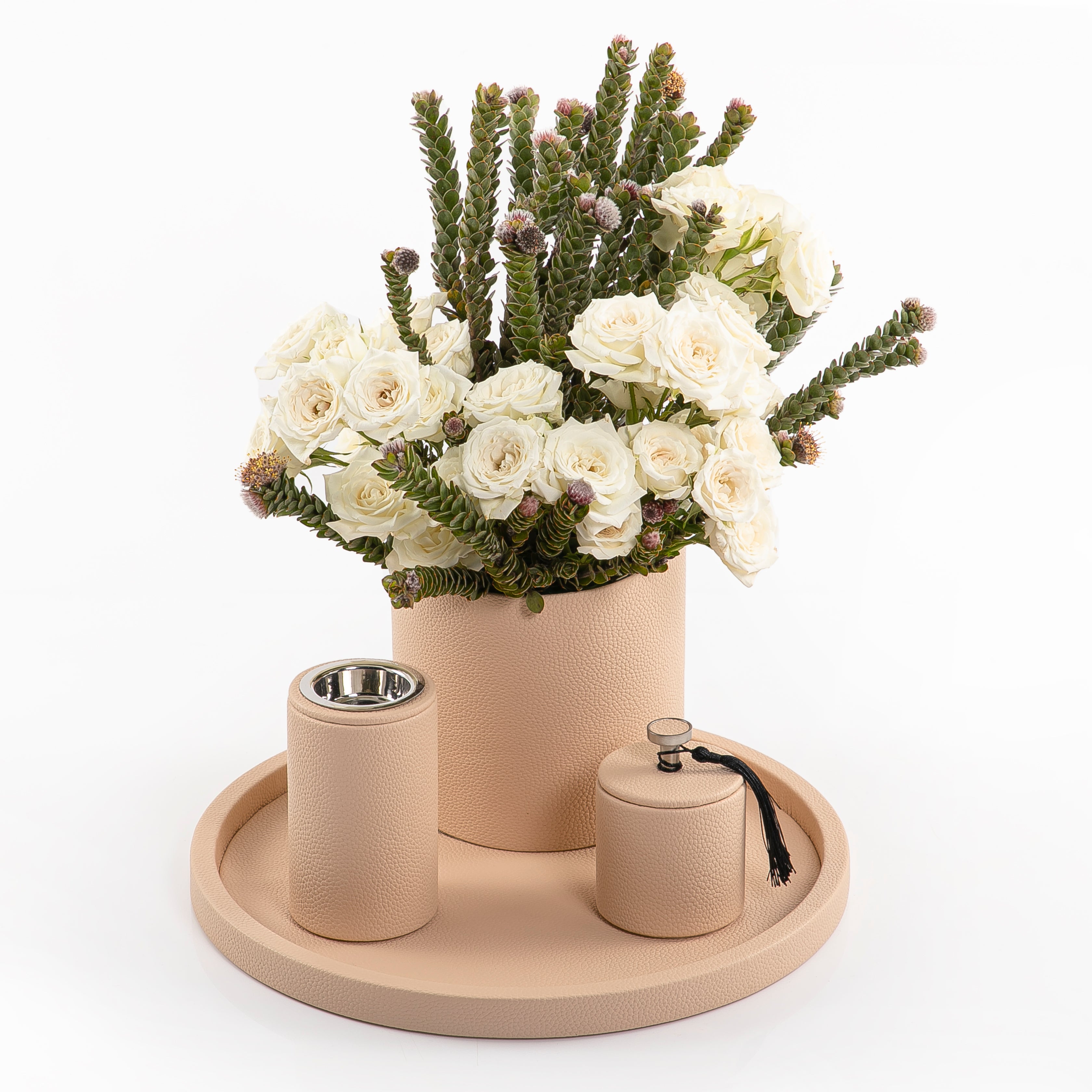 A beige leather set includes circle tray, incense burner, jar, and flower vase
