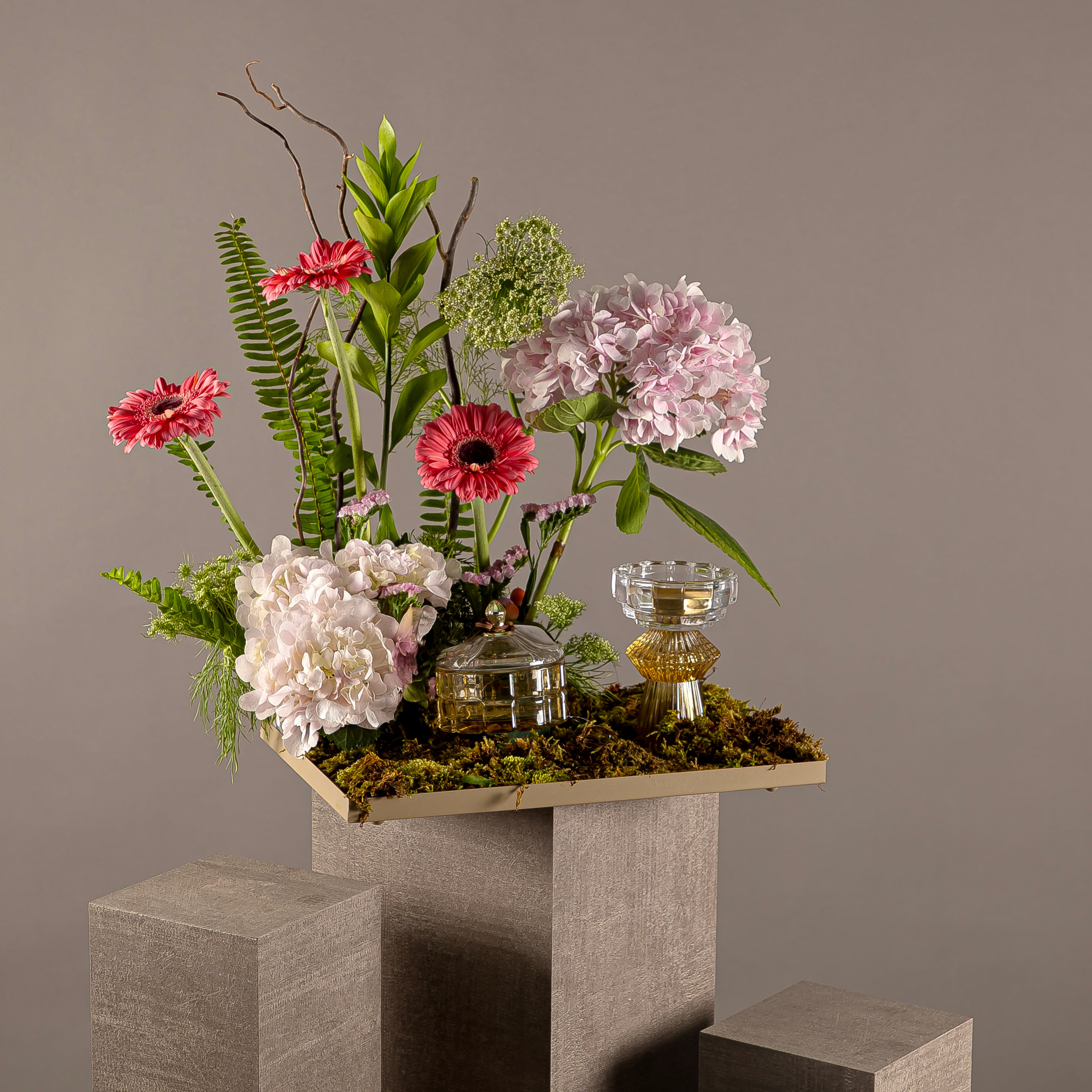 A tray decorated with various types of flowers, an incense burner and bowls