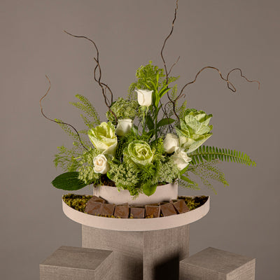 A chocolate tray decorated with white roses