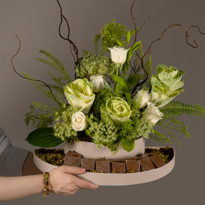 A chocolate tray decorated with white roses