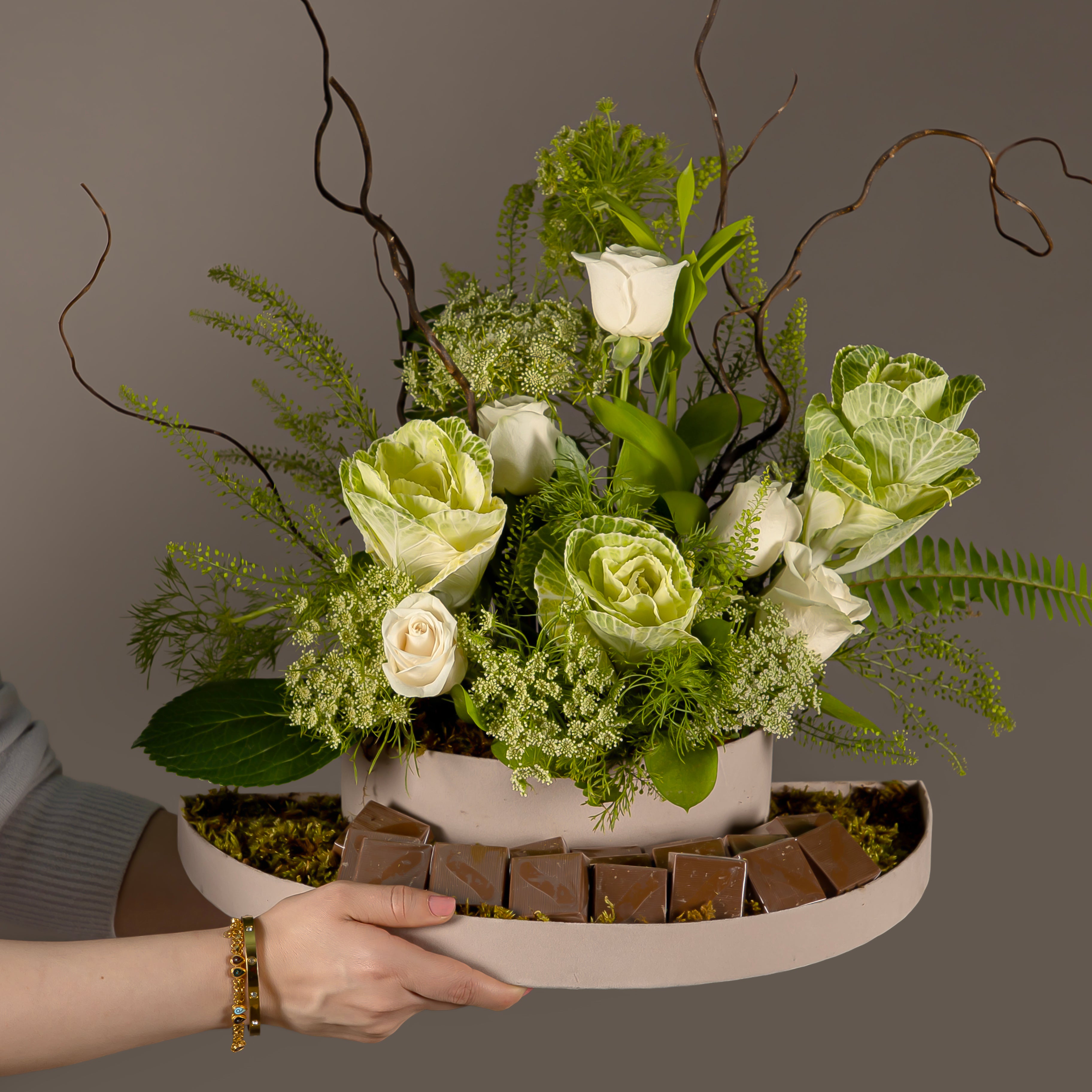 A chocolate tray decorated with white roses