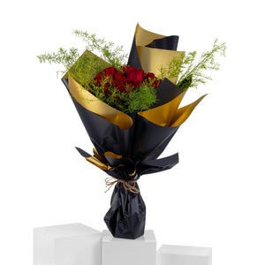 Elegant hand-tied bouquet featuring fresh red roses