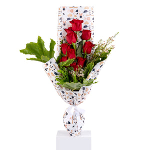Elegant hand-tied bouquet featuring fresh red roses