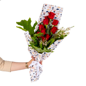 Elegant hand-tied bouquet featuring fresh red roses