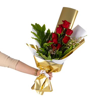 Elegant hand-tied bouquet featuring fresh red roses