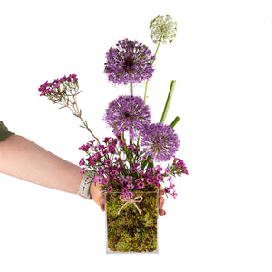 Elegant flower vase featuring fresh deferent types of purple flowers