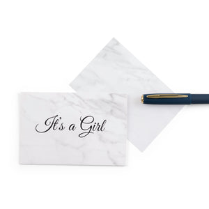 white marble new baby girl greeting card with the words 'It's a girl' written on it
