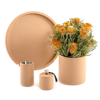 A brown leather set includes circle tray, incense burner, jar, and flower vase