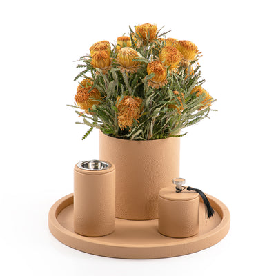 A brown leather set includes circle tray, incense burner, jar, and flower vase
